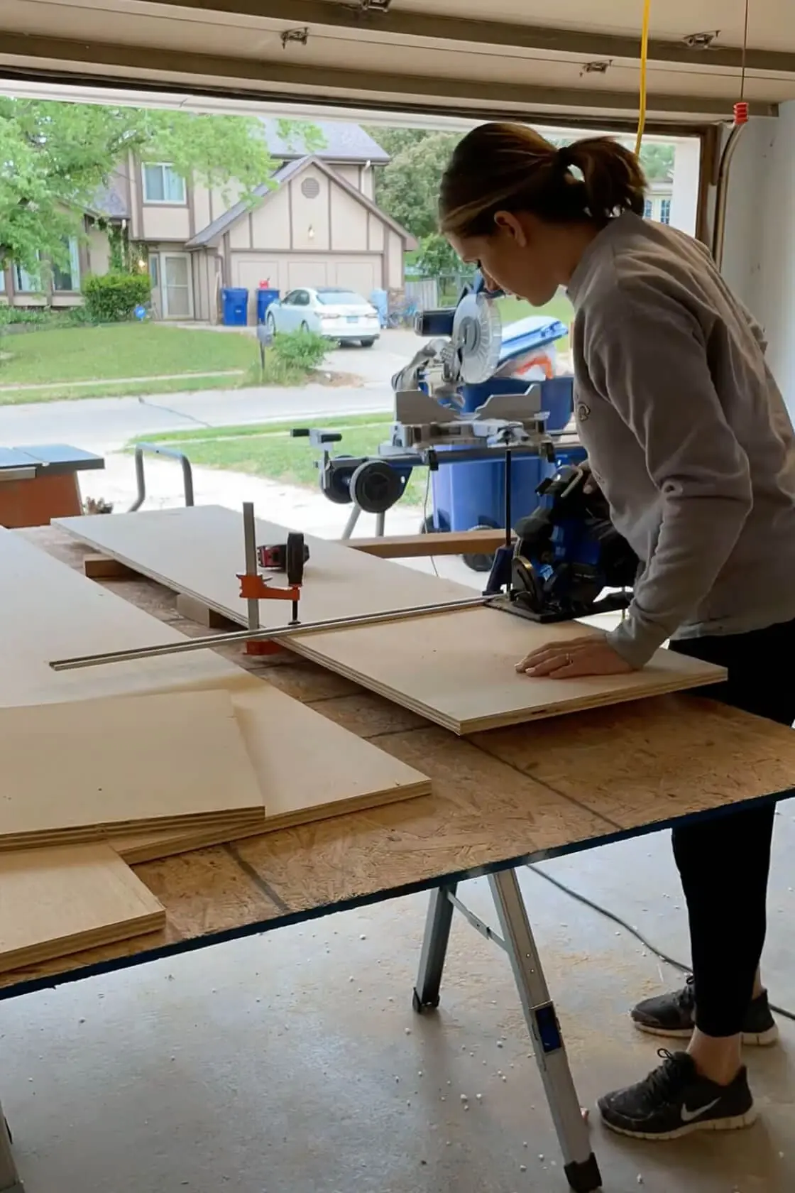 Using a circular saw to cut boards down for shelves.